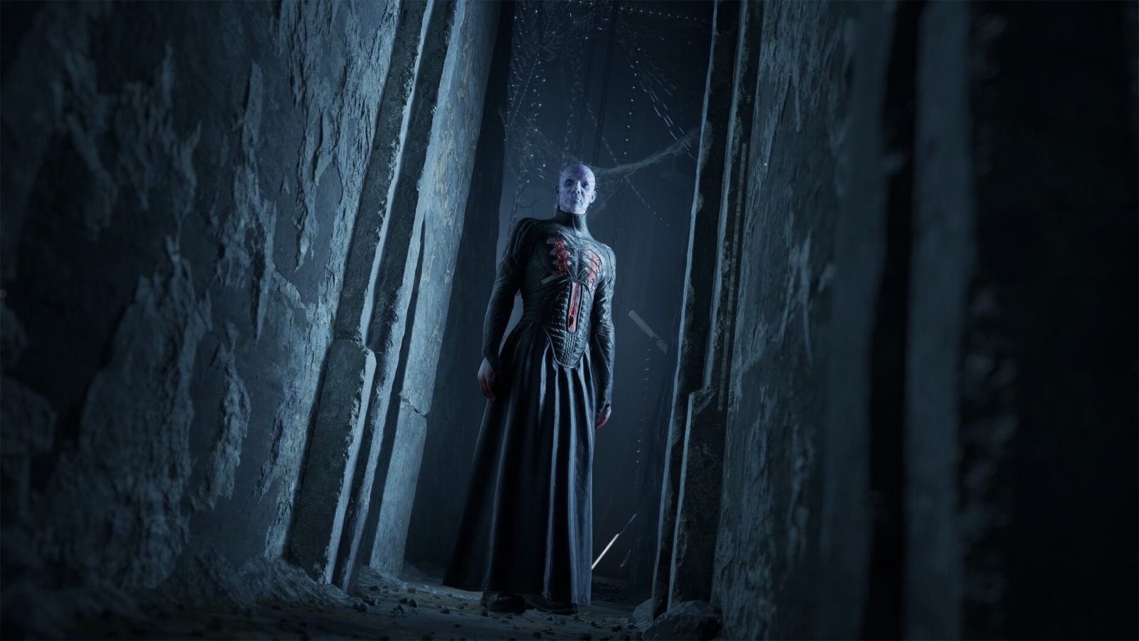 Pinhead stands in a stone passage inside the Labyrinth in Clive Barker's Hellraiser: Revival.